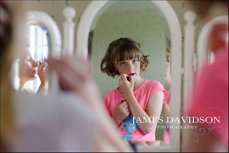surrey wedding photographer 04 bridesmaids putting make up on