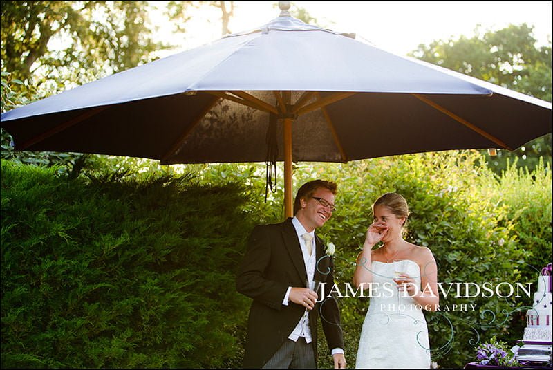 surrey wedding photographer 23 bride and groom laughing at speeches